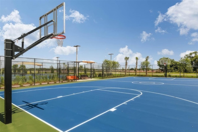 view of basketball court with community basketball court and fence