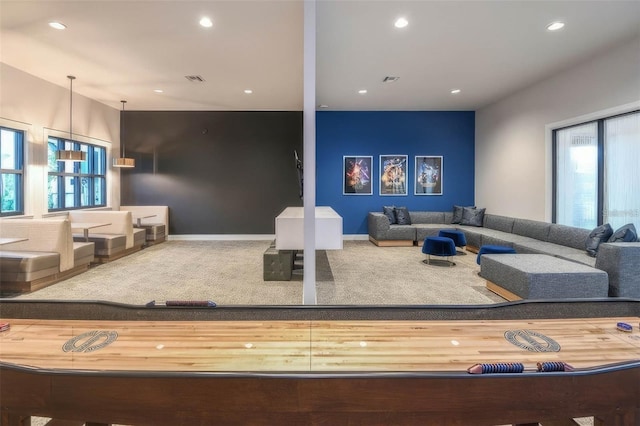 carpeted living room featuring plenty of natural light, recessed lighting, visible vents, and baseboards