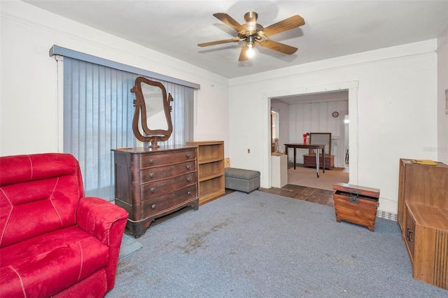 living area featuring carpet floors and ceiling fan