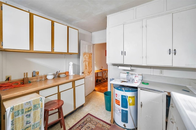 kitchen featuring water heater, white cabinets, and light countertops