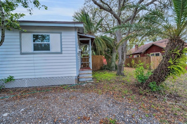 view of property exterior featuring fence