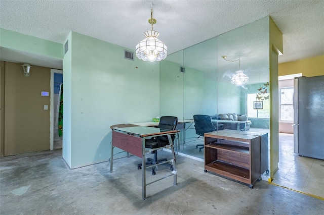 office area with a notable chandelier, visible vents, unfinished concrete floors, and a textured ceiling