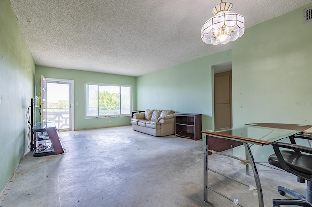 living room featuring a notable chandelier, visible vents, a textured ceiling, and unfinished concrete flooring