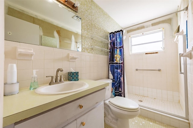 full bath featuring toilet, a stall shower, tasteful backsplash, tile walls, and vanity