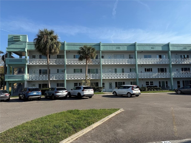 view of building exterior featuring uncovered parking