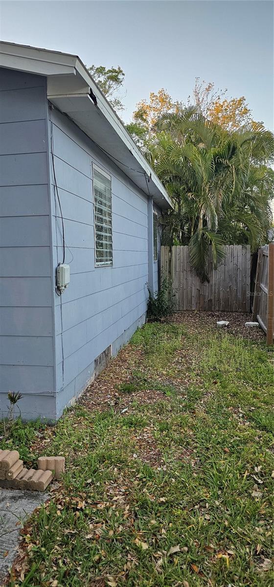 view of property exterior featuring crawl space and fence