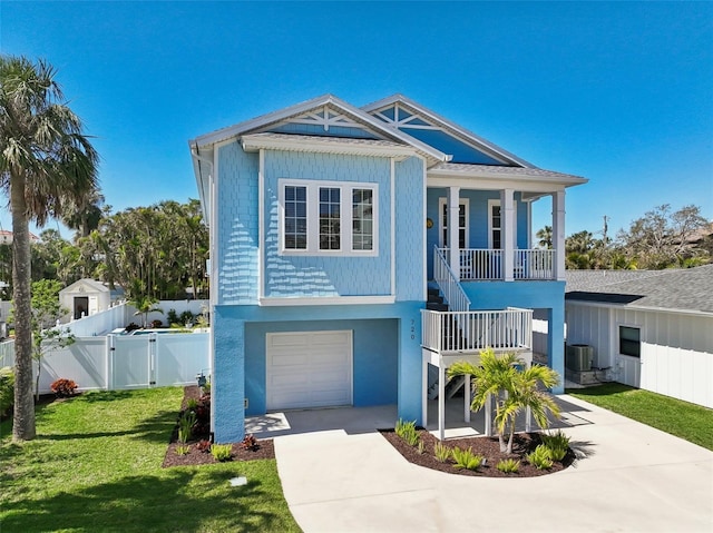 coastal inspired home with central air condition unit, a porch, stairs, driveway, and a gate