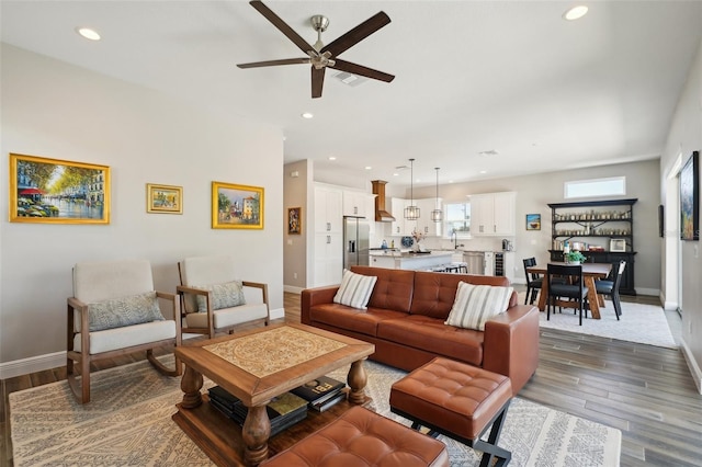 living area with recessed lighting, baseboards, and dark wood-style floors