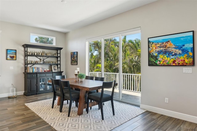 dining area featuring a wealth of natural light, baseboards, and wood finished floors