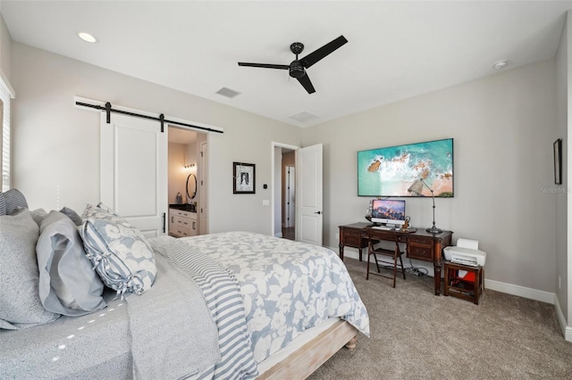 bedroom with visible vents, light carpet, a ceiling fan, a barn door, and baseboards