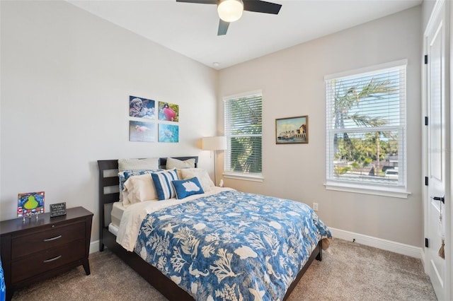 carpeted bedroom with baseboards and ceiling fan