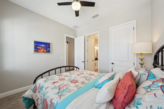 carpeted bedroom featuring a ceiling fan, ensuite bath, baseboards, and visible vents