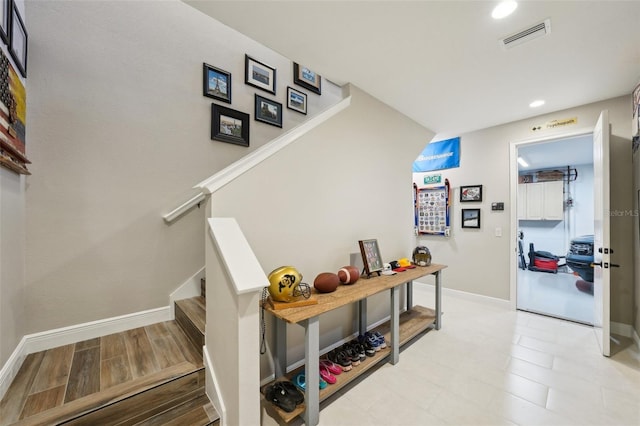 stairs with recessed lighting, visible vents, baseboards, and wood finished floors