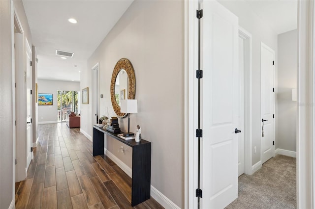 corridor with visible vents, recessed lighting, baseboards, and wood finished floors