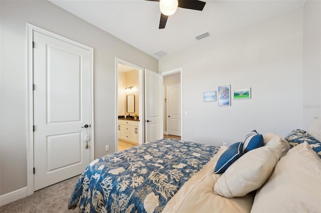 bedroom with a ceiling fan, baseboards, visible vents, light carpet, and connected bathroom