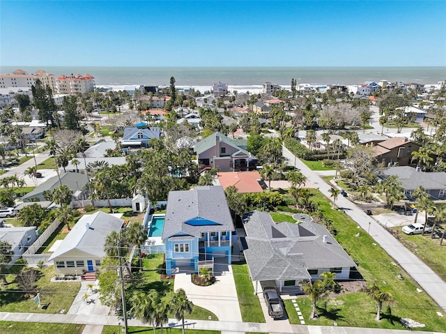 drone / aerial view featuring a water view and a residential view