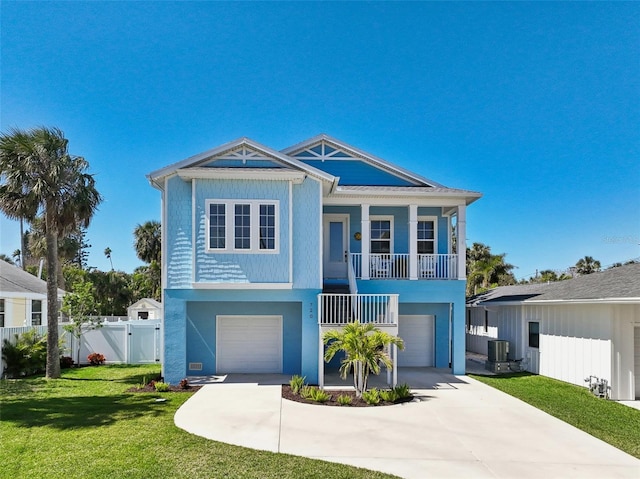 720 Bay Esplanade, Clearwater Beach, FL 33767 - coastal home with a garage, a gate, driveway, and central air condition unit