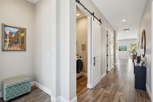 720 Bay Esplanade, Clearwater Beach, FL 33767 - hall with wood finished floors, a barn door, washer / clothes dryer, baseboards, and recessed lighting