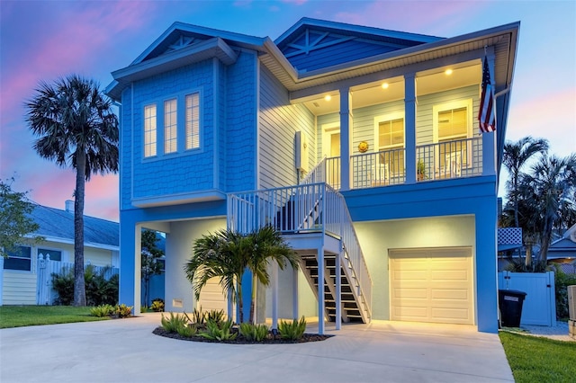 720 Bay Esplanade, Clearwater Beach, FL 33767 - view of front of house with concrete driveway, stairs, an attached garage, covered porch, and fence