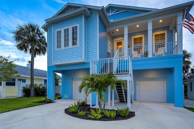 720 Bay Esplanade, Clearwater Beach, FL 33767 - view of front of house featuring stairs, an attached garage, and driveway