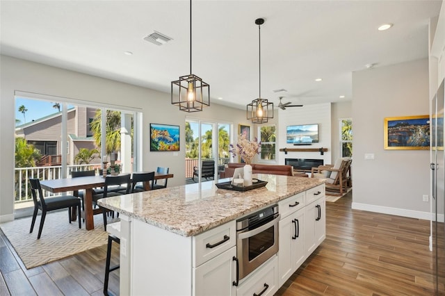 720 Bay Esplanade, Clearwater Beach, FL 33767 - kitchen featuring dark wood finished floors, baseboards, recessed lighting, white cabinetry, and decorative light fixtures