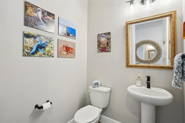 720 Bay Esplanade, Clearwater Beach, FL 33767 - bathroom with toilet, baseboards, and a sink
