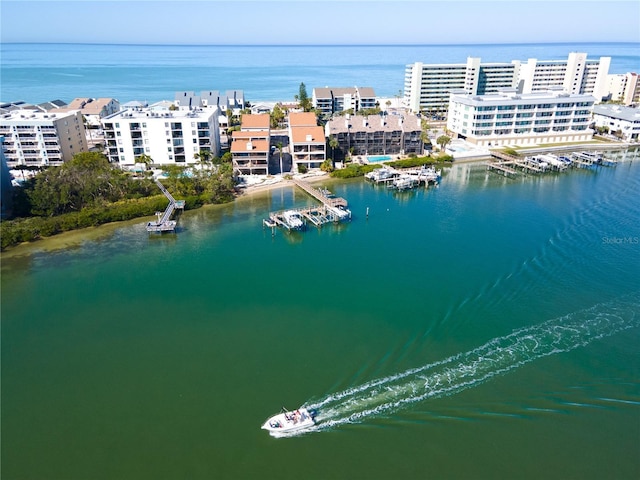 birds eye view of property with a city view and a water view