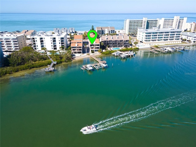 birds eye view of property with a city view and a water view