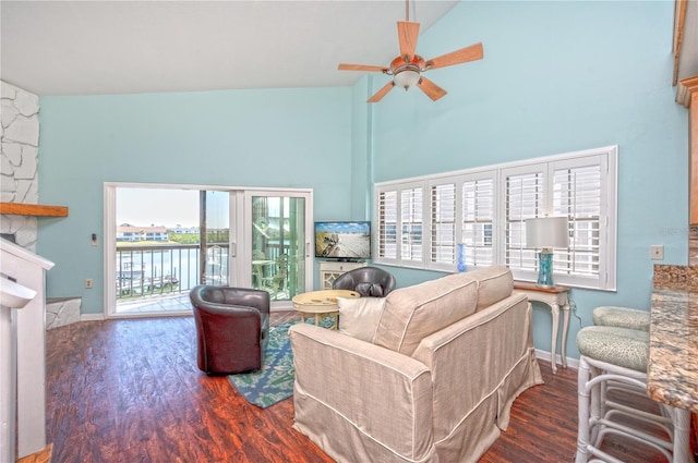 living room with baseboards, high vaulted ceiling, wood finished floors, and a ceiling fan