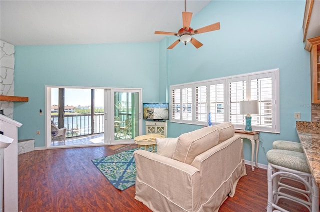 living area featuring a healthy amount of sunlight, a ceiling fan, and wood finished floors