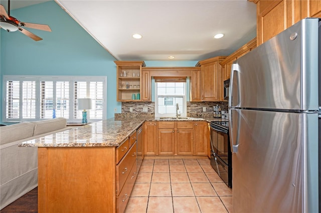 kitchen featuring light tile patterned floors, light stone countertops, open shelves, a peninsula, and stainless steel appliances