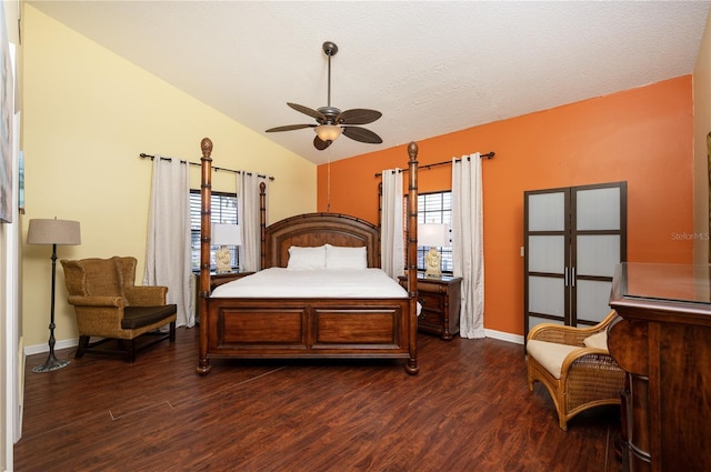 bedroom with lofted ceiling, baseboards, dark wood-style flooring, and ceiling fan