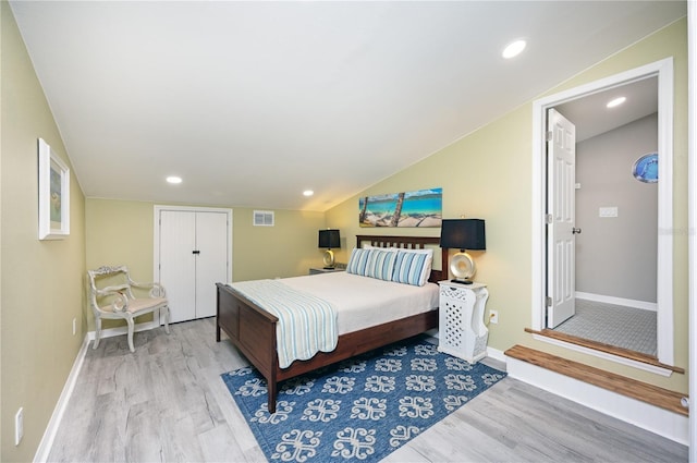 bedroom with wood finished floors, visible vents, baseboards, recessed lighting, and vaulted ceiling