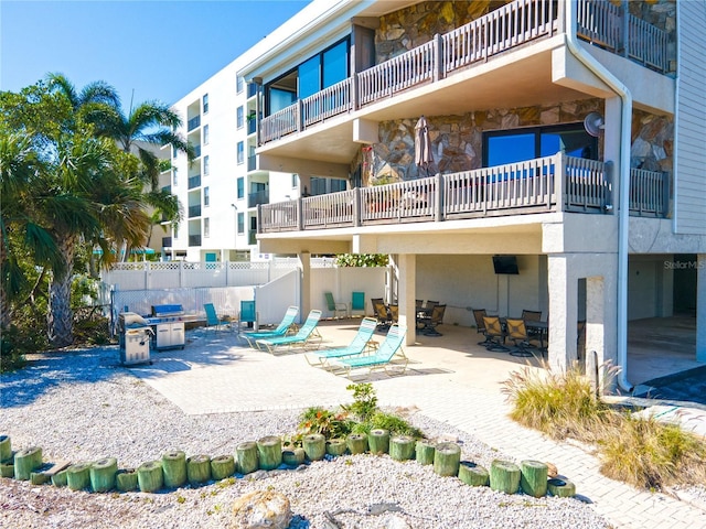 view of home's community with a patio area and fence