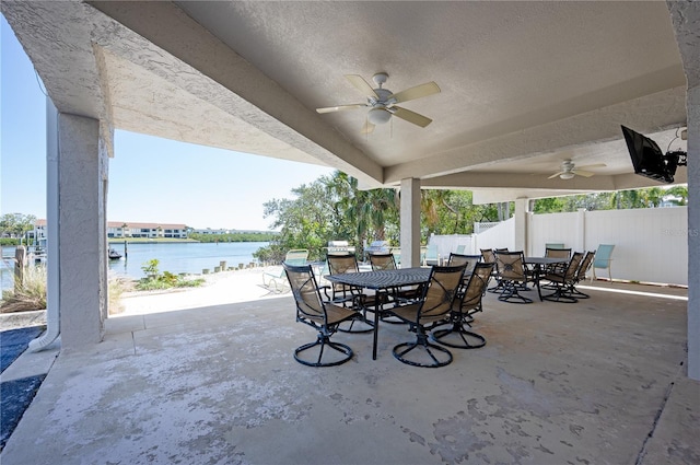 view of patio featuring outdoor dining space, a ceiling fan, and fence