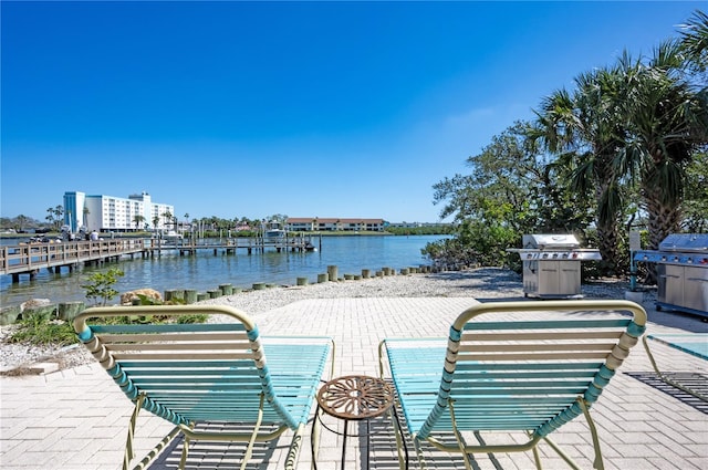 exterior space featuring a water view and a grill