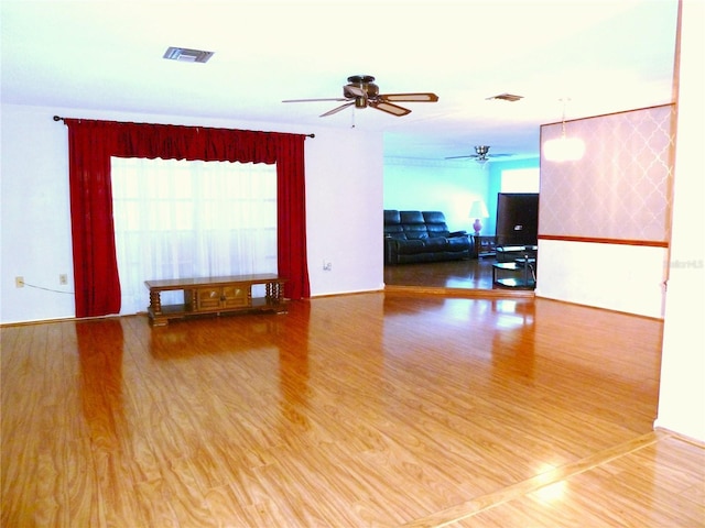 unfurnished room featuring visible vents, ceiling fan, and wood finished floors