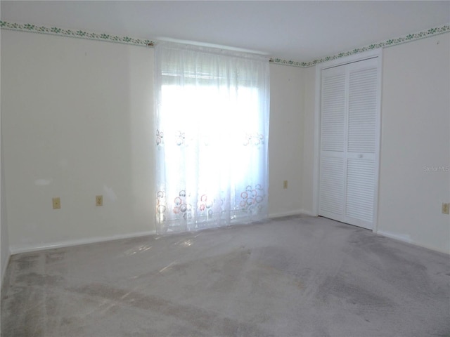 unfurnished bedroom featuring a closet and carpet flooring