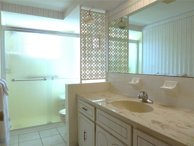 full bath with tile patterned flooring, backsplash, toilet, a stall shower, and vanity