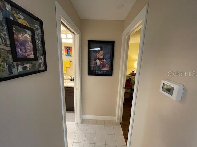 hall with light tile patterned floors and baseboards