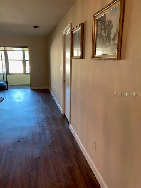 1601 43rd St N Unit 226, Saint Petersburg, FL 33713 - hallway with dark wood-style flooring, baseboards, and visible vents