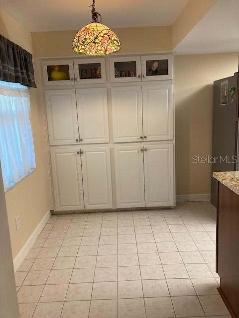 1601 43rd St N Unit 226, Saint Petersburg, FL 33713 - unfurnished dining area featuring light tile patterned floors and baseboards