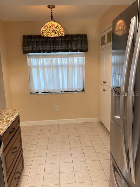 1601 43rd St N Unit 226, Saint Petersburg, FL 33713 - unfurnished dining area with baseboards and light tile patterned flooring