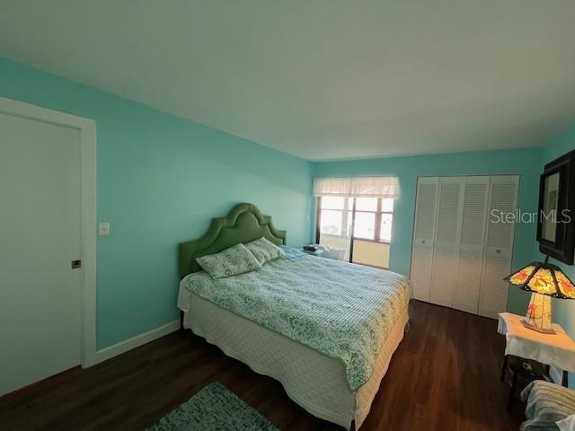 1601 43rd St N Unit 226, Saint Petersburg, FL 33713 - bedroom featuring a closet, baseboards, and dark wood-style floors