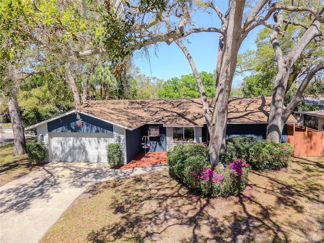 view of front of house featuring concrete driveway and an attached garage