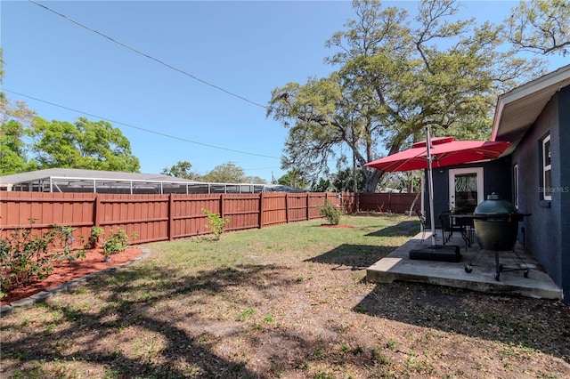 view of yard featuring a patio area and a fenced backyard