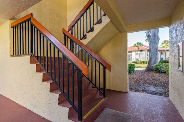 staircase with a textured wall