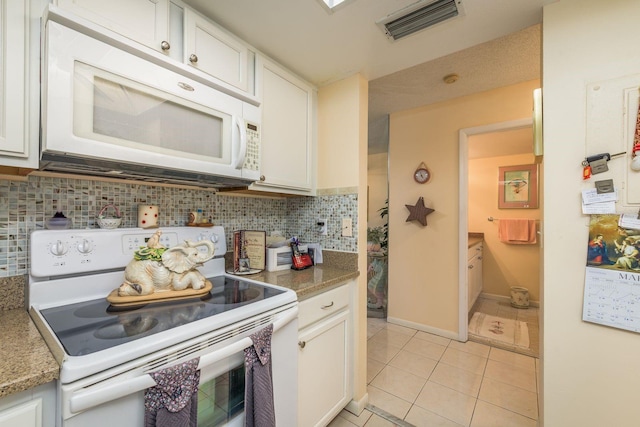 kitchen featuring visible vents, tasteful backsplash, white cabinetry, white appliances, and light tile patterned floors