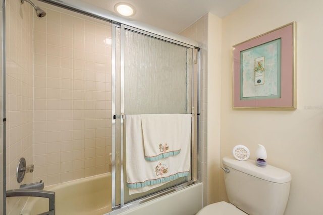 bathroom with shower / bath combination with glass door and toilet