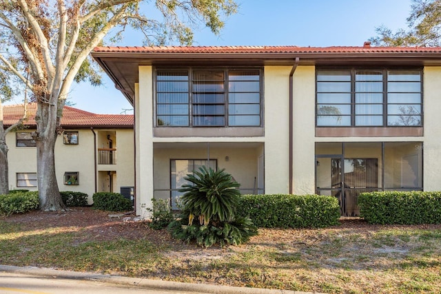 view of front of house featuring a tile roof and stucco siding